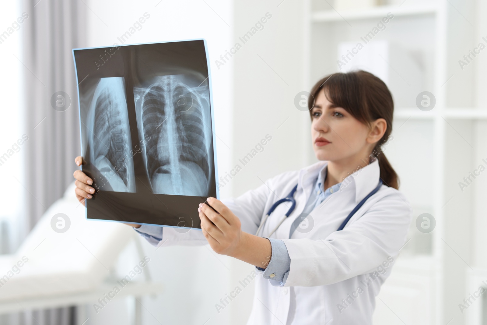 Photo of Lung disease. Doctor examining chest x-ray in clinic