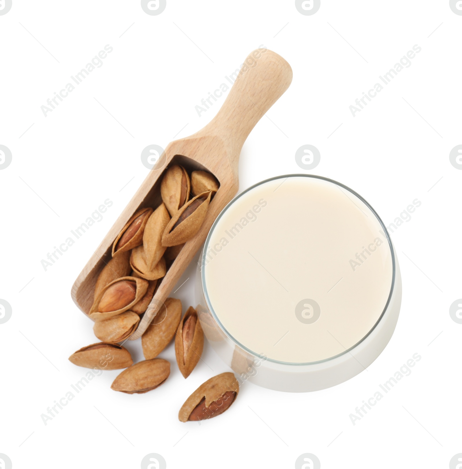 Photo of Glass of almond milk and almonds isolated on white, top view