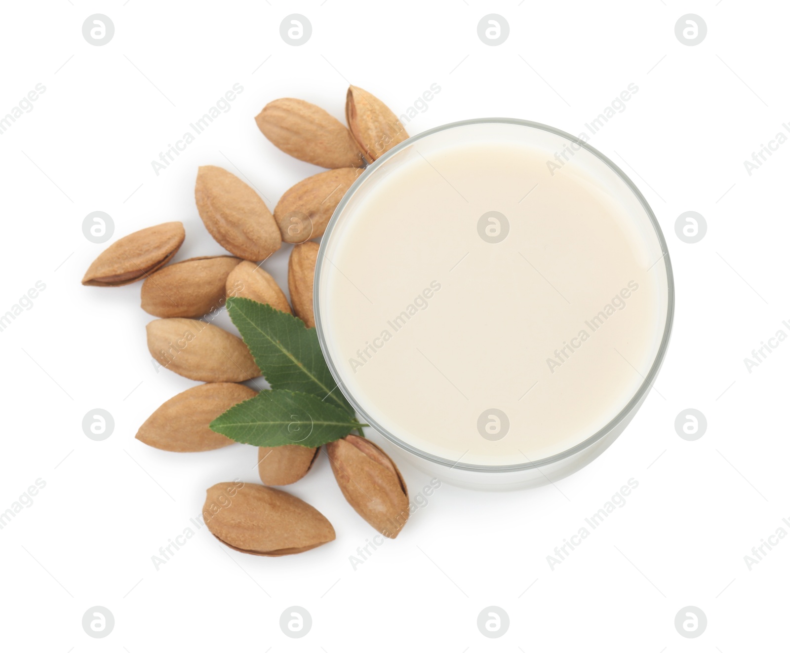 Photo of Glass of almond milk and almonds isolated on white, top view