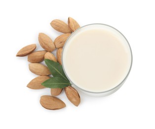 Photo of Glass of almond milk and almonds isolated on white, top view