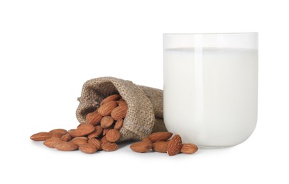 Glass of almond milk and almonds isolated on white