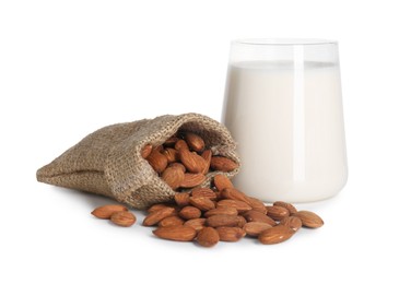 Photo of Glass of almond milk and almonds isolated on white