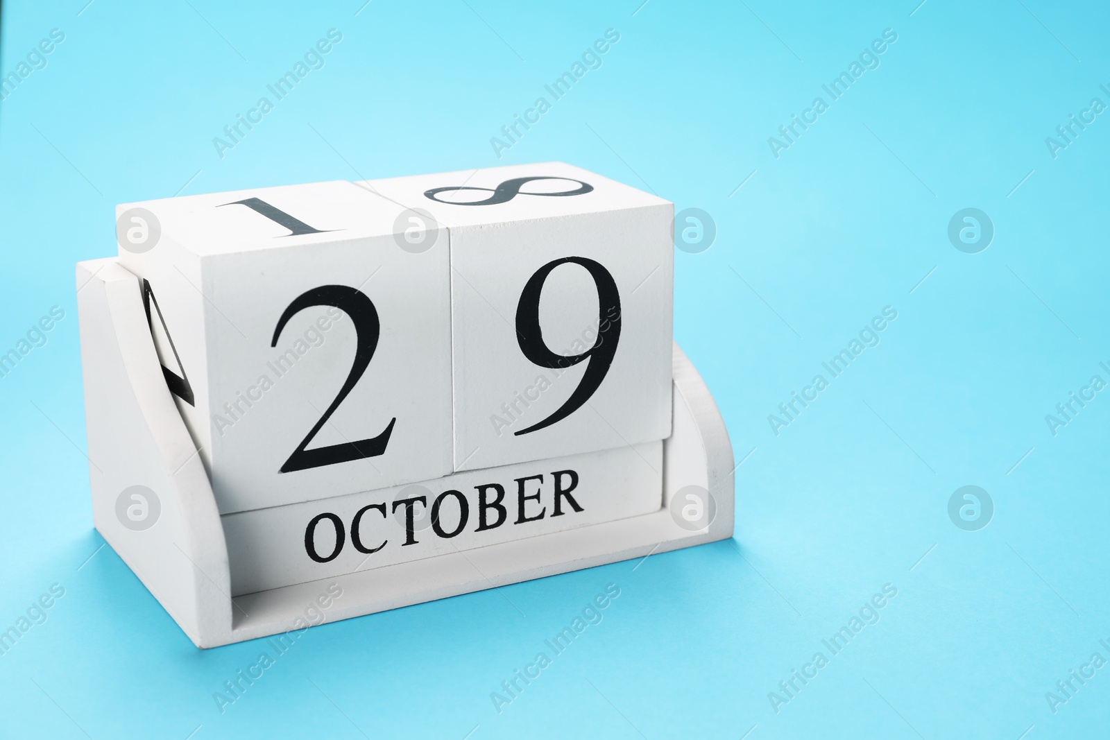 Photo of International Psoriasis Day - 29th of October. Block calendar on light blue background, space for text