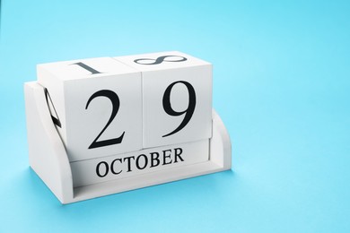 Photo of International Psoriasis Day - 29th of October. Block calendar on light blue background, space for text