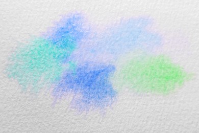 Photo of Abstract watercolor painting on white sheet of paper, top view