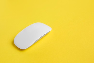 Photo of One wireless mouse on yellow background. Space for text