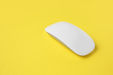 Photo of One wireless mouse on yellow background. Space for text