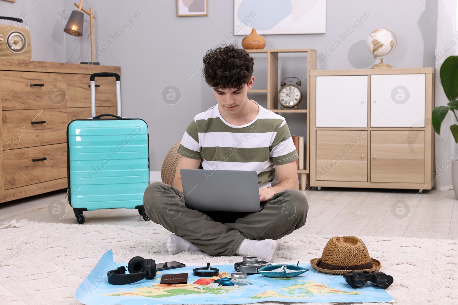 Photo of Travel blogger using laptop for planning trip at home