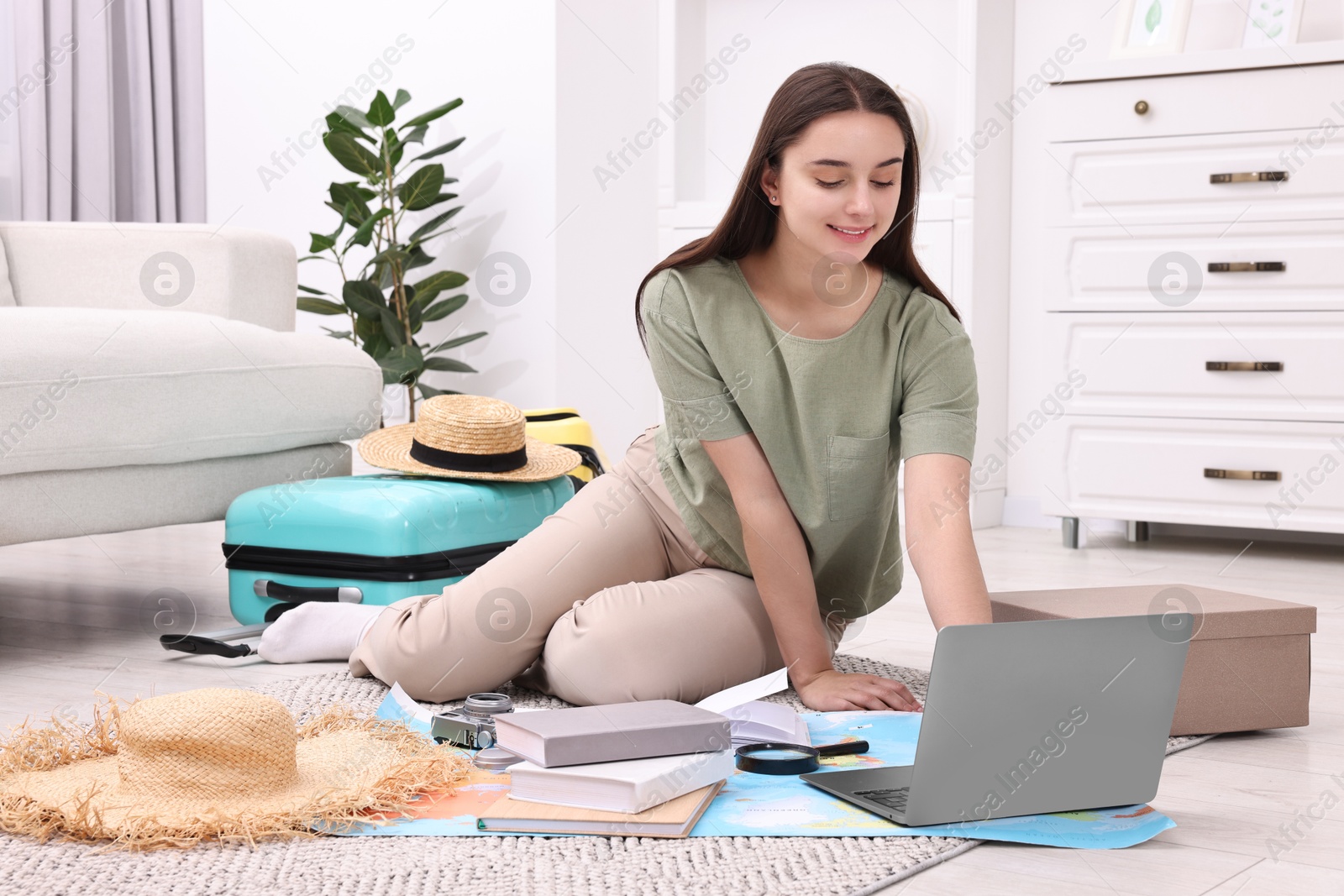 Photo of Travel blogger using laptop for planning trip at home