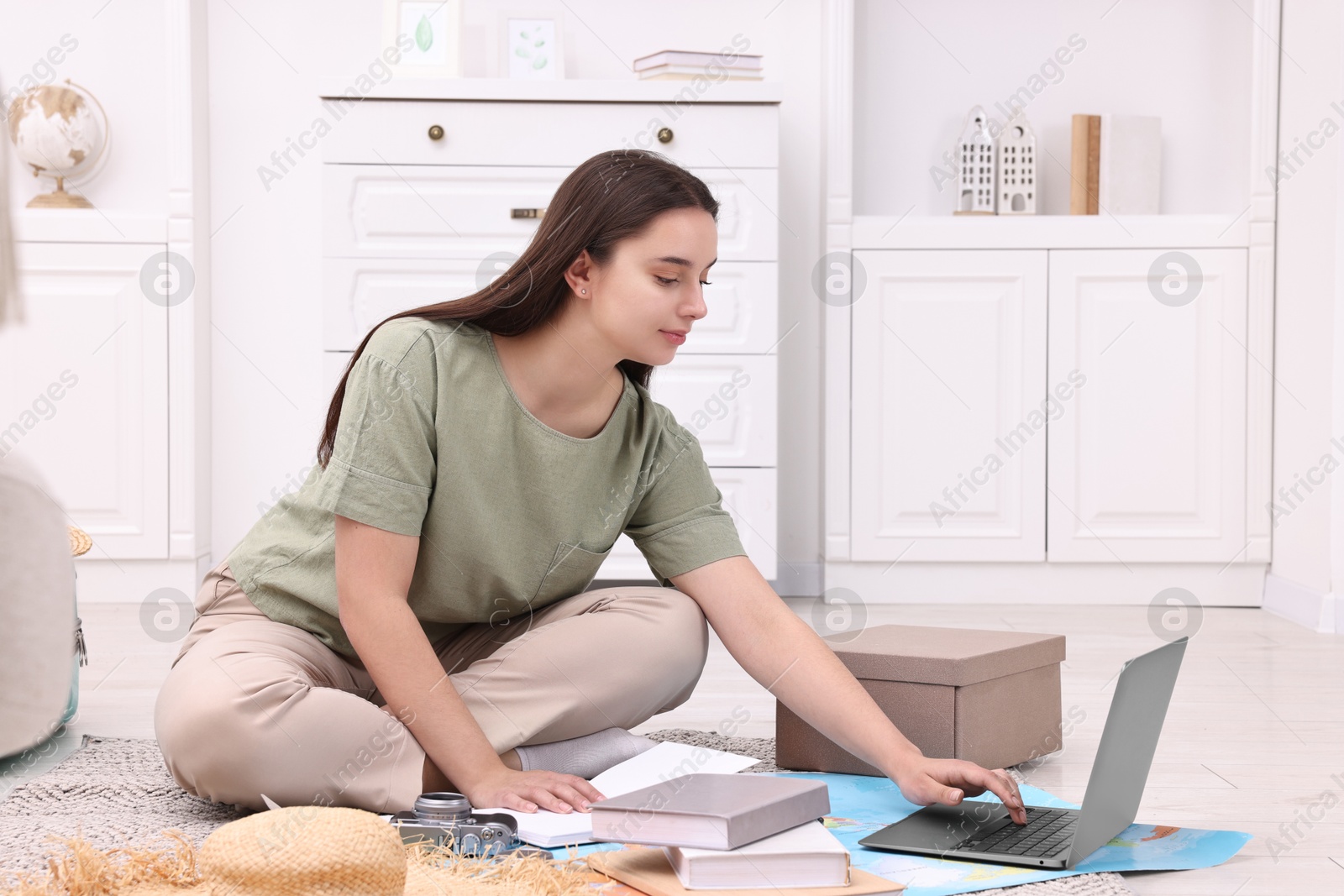 Photo of Travel blogger using laptop for planning trip at home