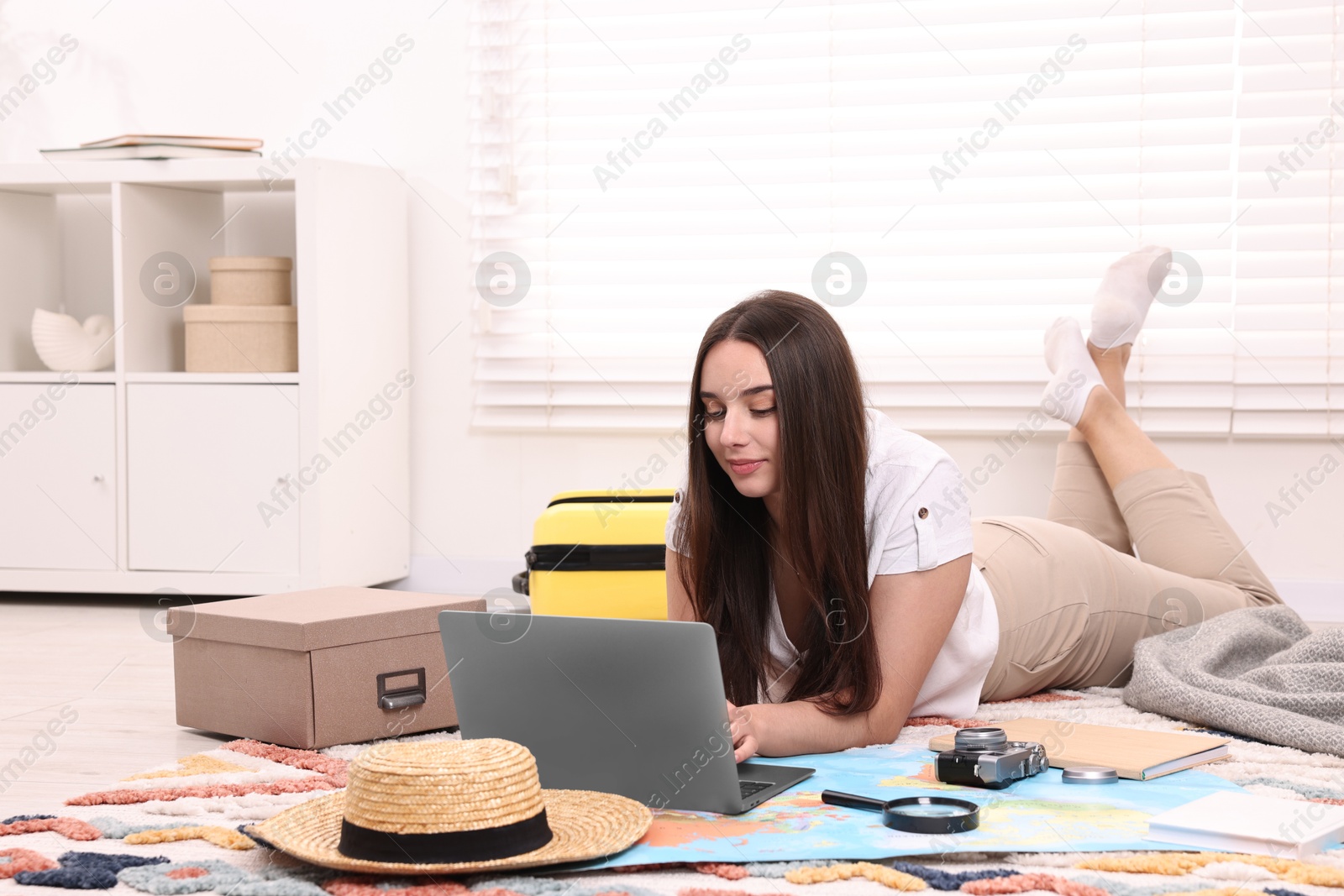 Photo of Travel blogger using laptop for planning trip at home