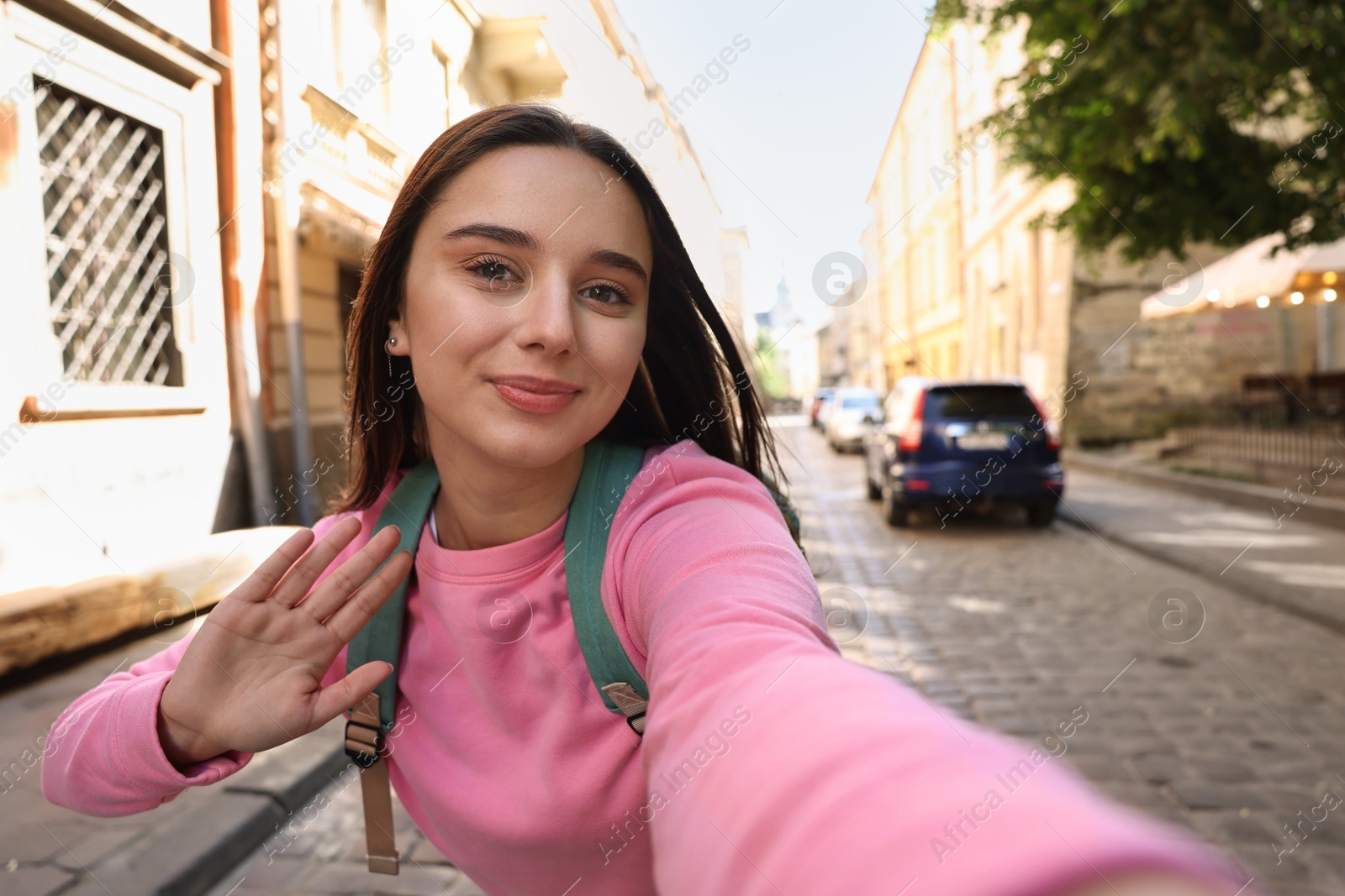 Photo of Beautiful young travel blogger streaming on city street