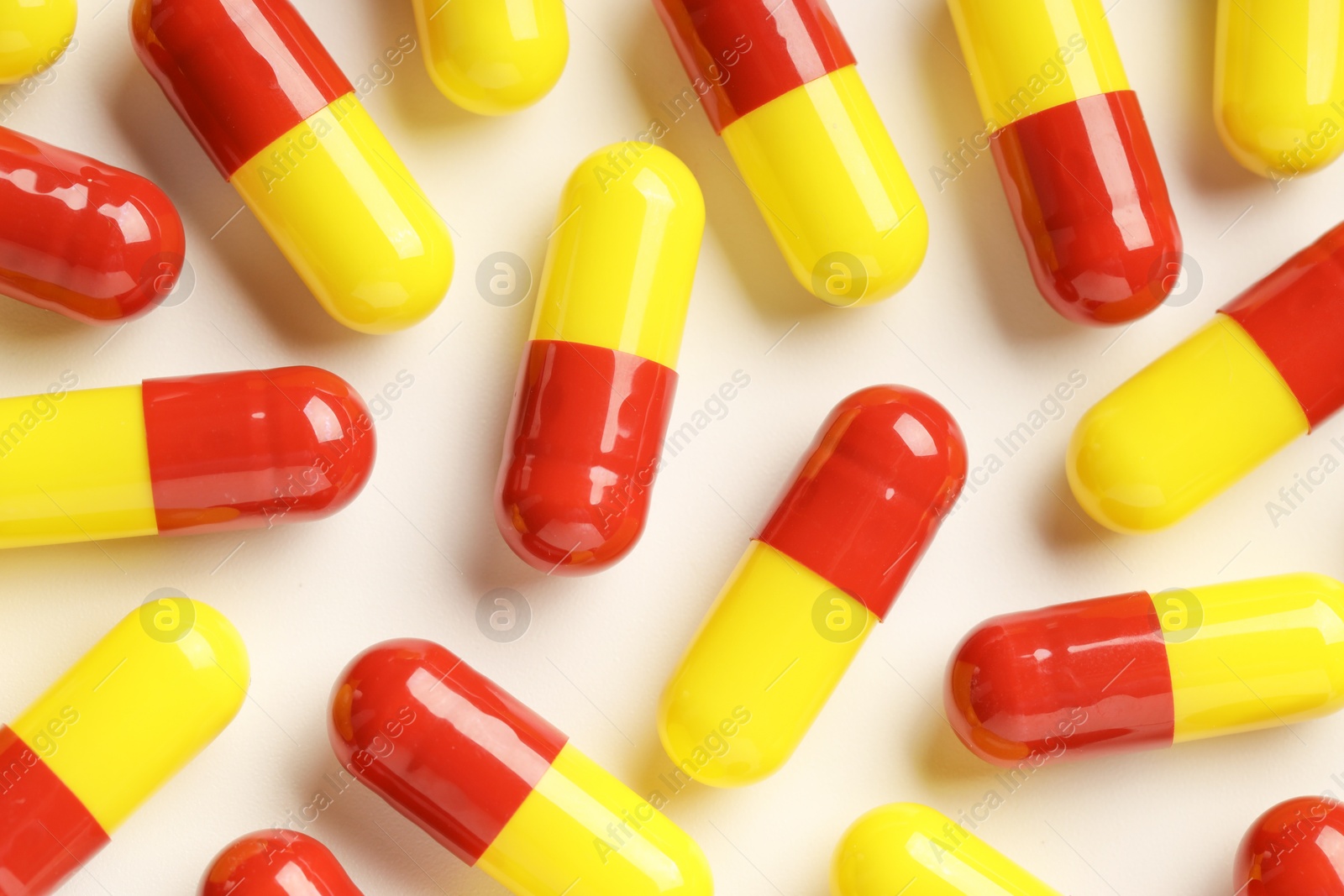 Photo of Many antibiotic pills on white background, top view