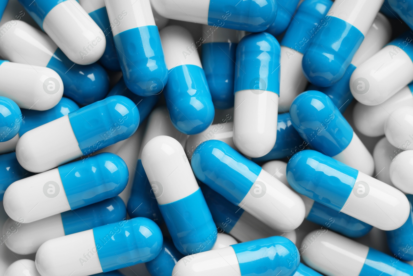 Photo of Many antibiotic pills as background, top view