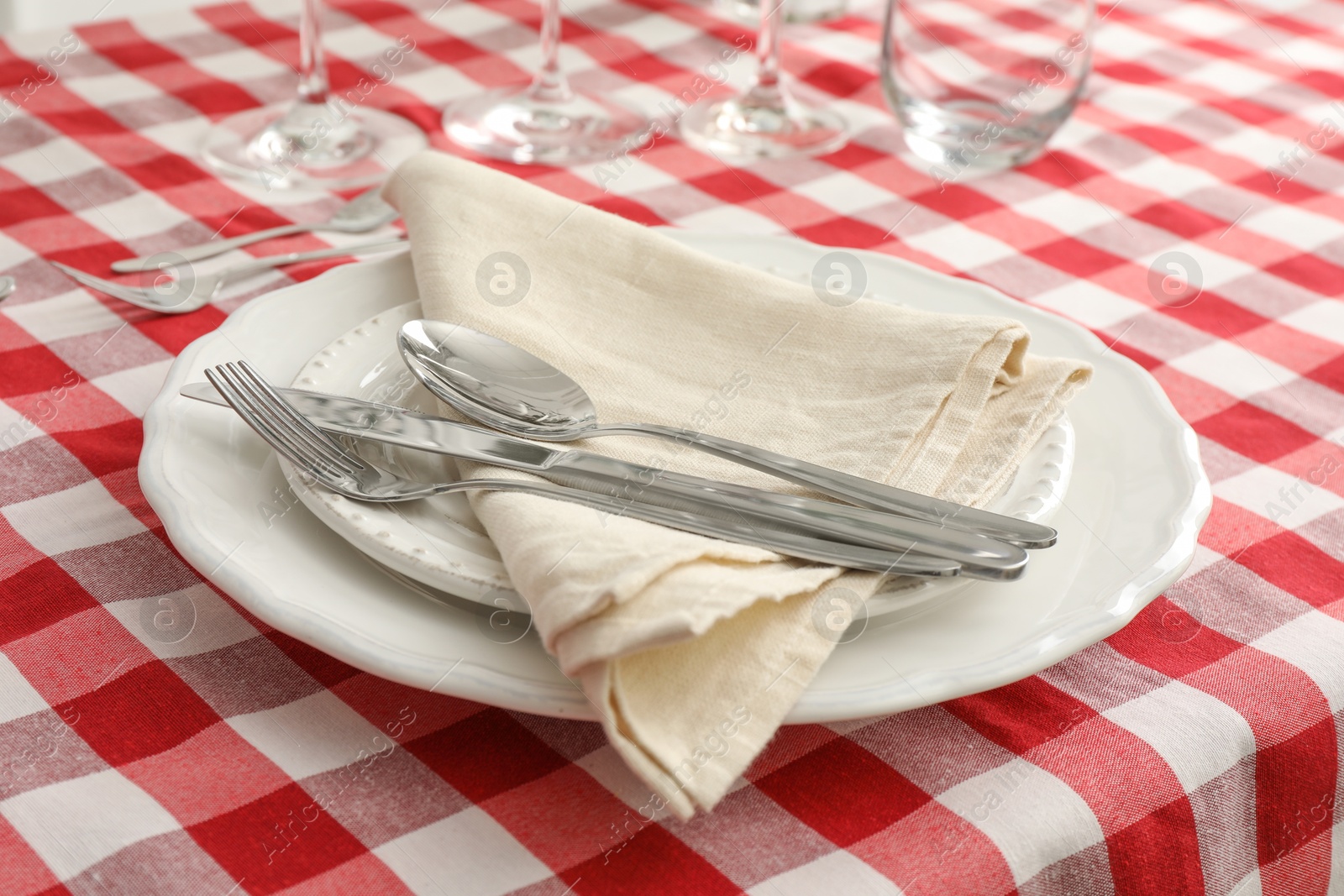 Photo of Stylish setting with cutlery, plates and napkin on table