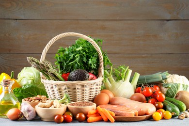 Photo of Healthy food. Basket with different fresh products on grey table