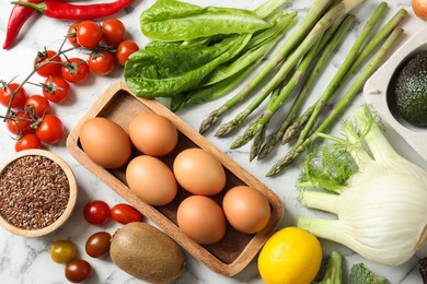 Photo of Many different healthy food on light marble table, flat lay