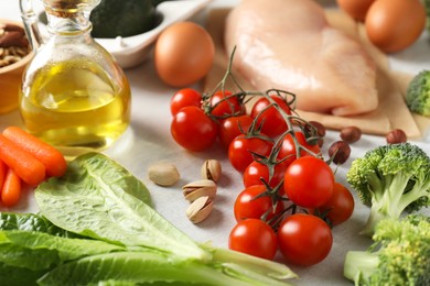 Photo of Many different healthy food on white table, closeup