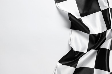 Photo of One checkered flag on white background, top view. Space for text