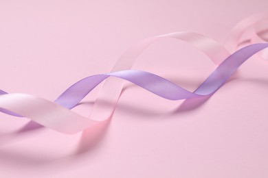 Photo of Beautiful ribbons in different colors on pink background