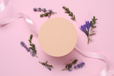 Photo of Beautiful ribbon and round shaped podium on pink background, flat lay