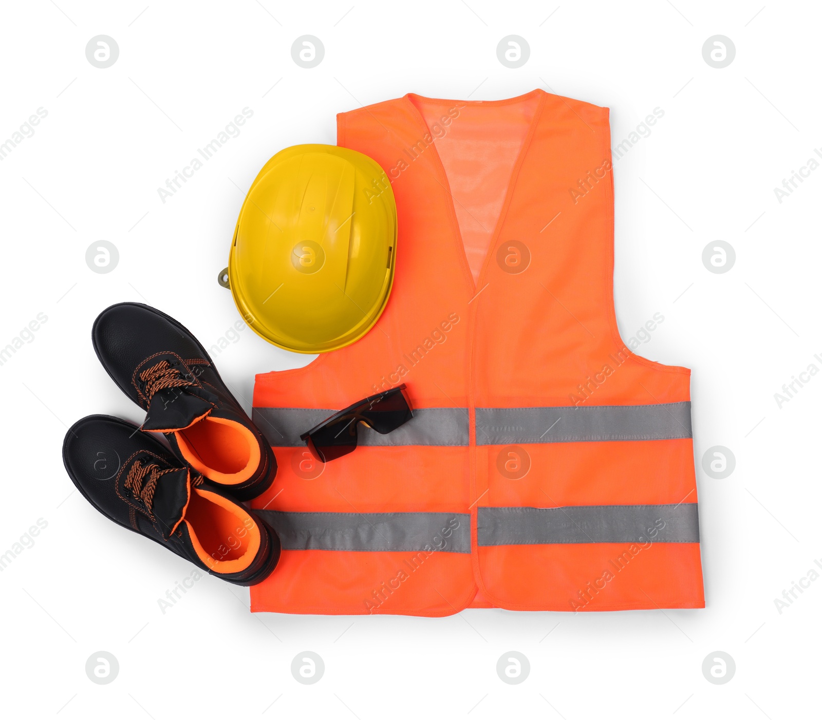 Photo of Orange reflective vest, pair of working boots, hard hat and goggles isolated on white, top view