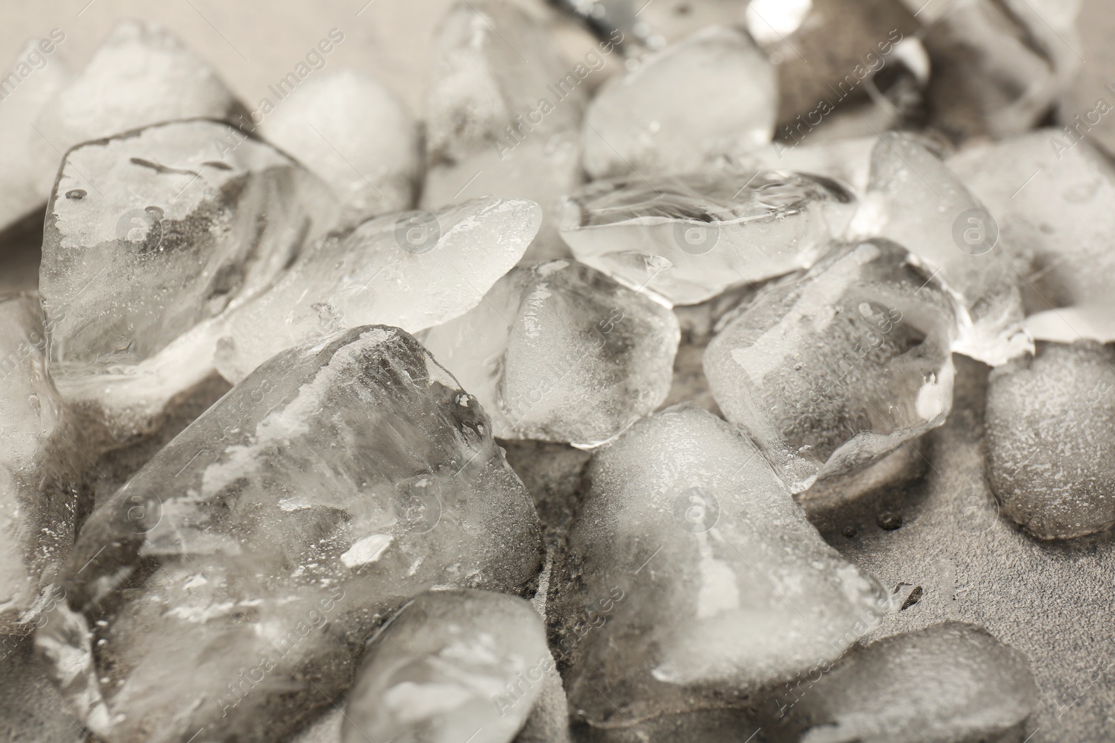Photo of Pile of crushed ice on grey textured table, closeup