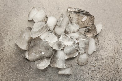 Photo of Pile of crushed ice on dark textured table, top view