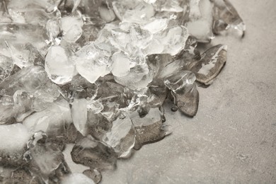 Photo of Pile of crushed ice on dark textured table, above view