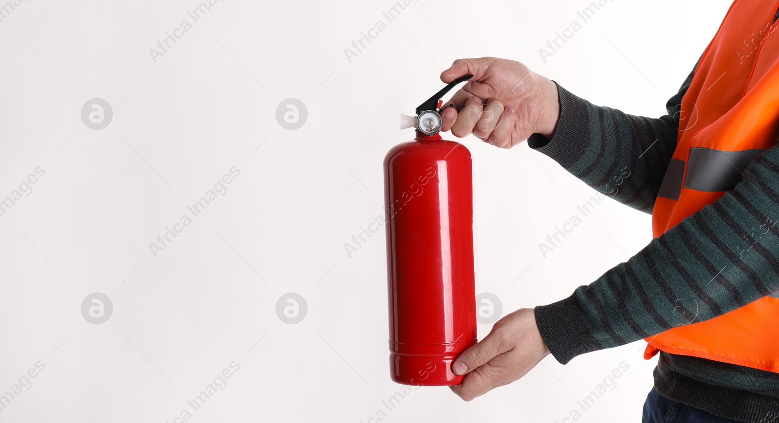 Photo of Man with fire extinguisher on light background, closeup. Space for text