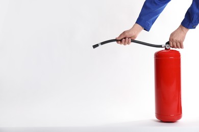 Photo of Man with fire extinguisher on white background, closeup. Space for text