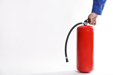 Photo of Man with fire extinguisher on white background, closeup. Space for text