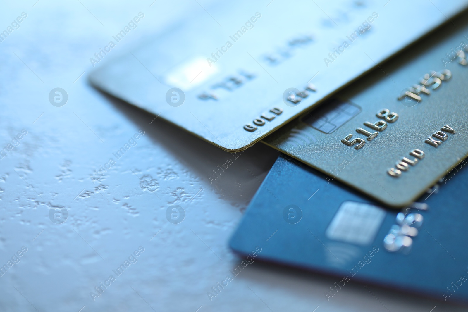 Photo of Plastic credit cards on table, closeup view. Space for text