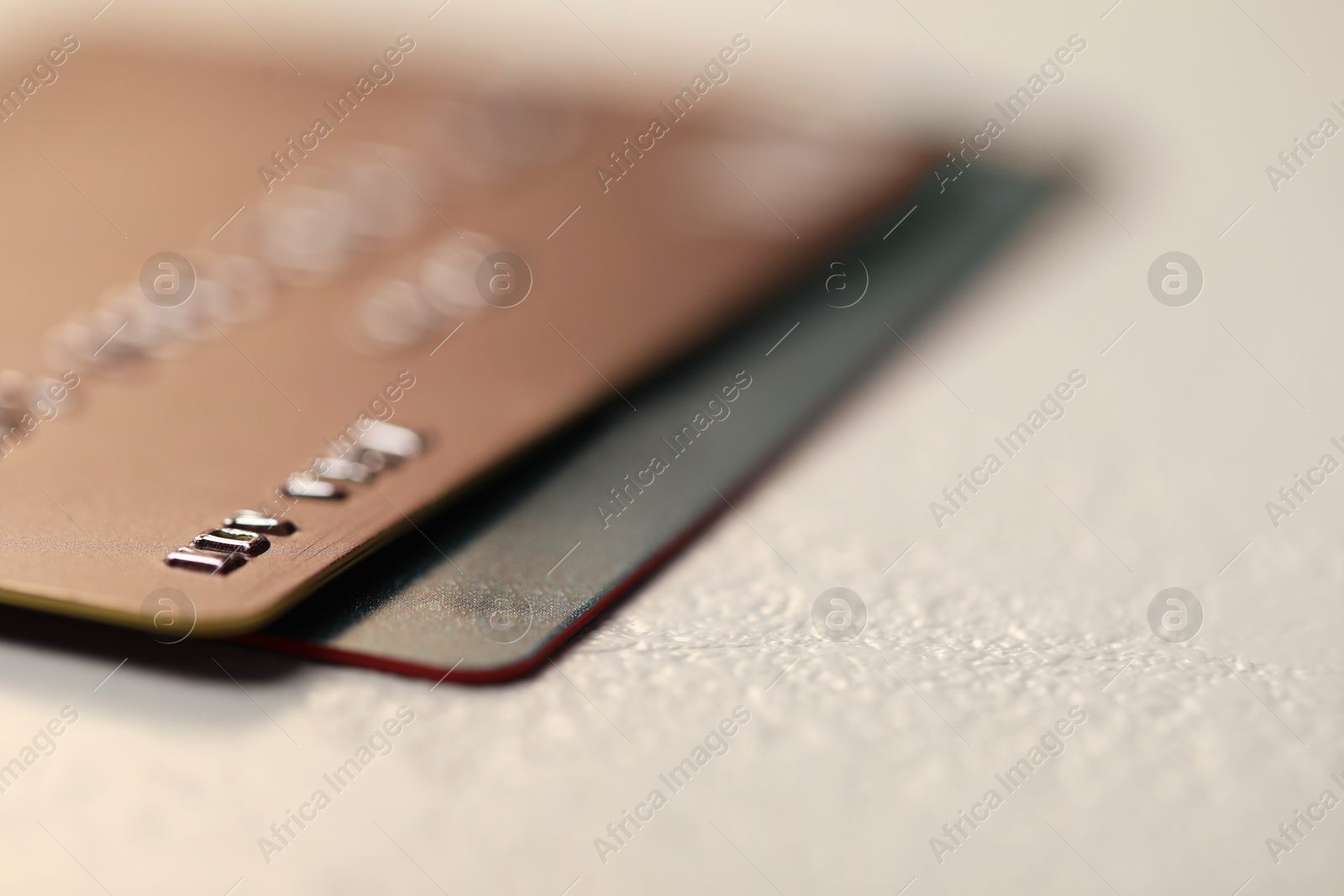 Photo of Two credit cards on gray background, closeup