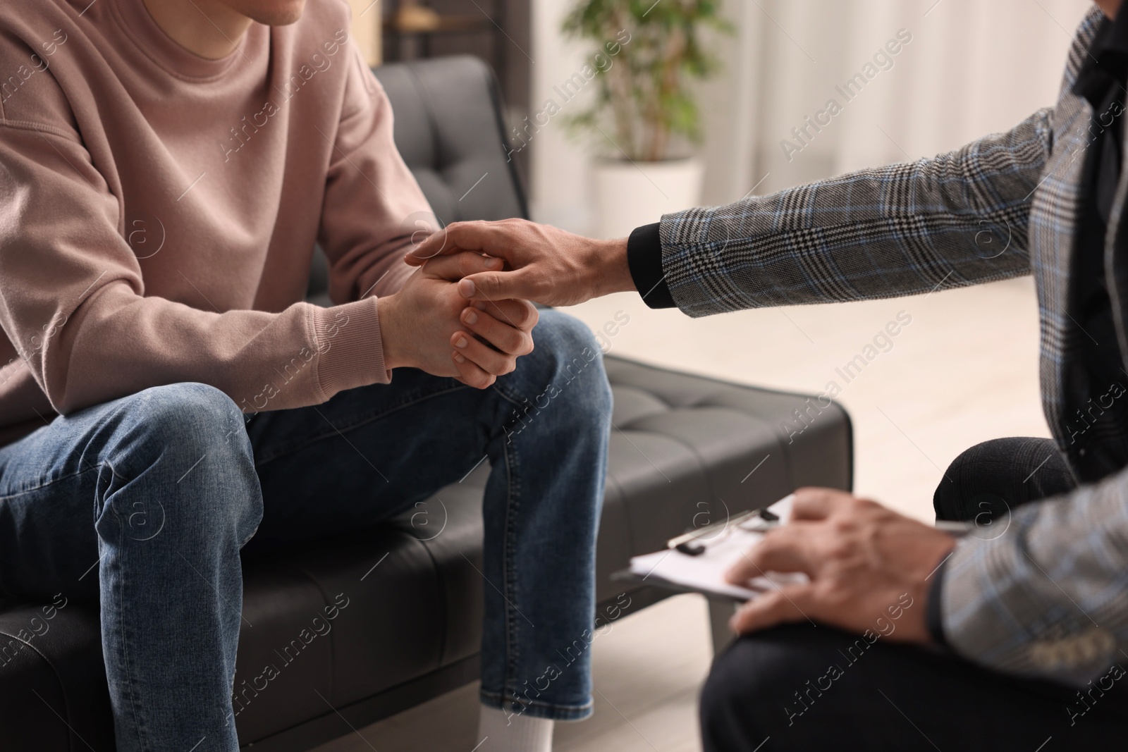 Photo of Professional psychotherapist working with patient in office, closeup