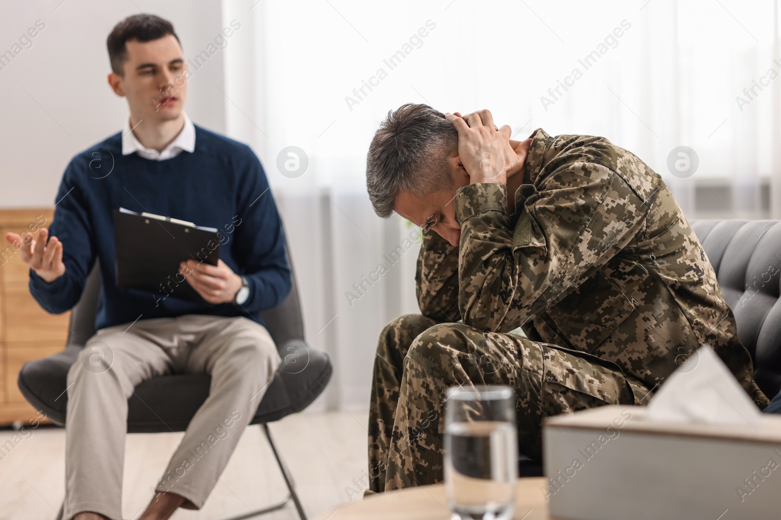 Photo of Professional psychotherapist working with military man in office