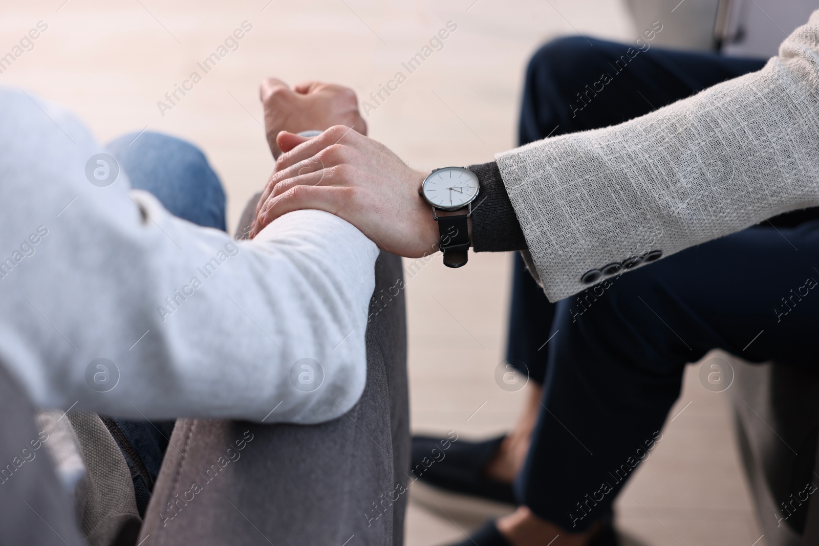 Photo of Professional psychotherapist working with patient in office, closeup