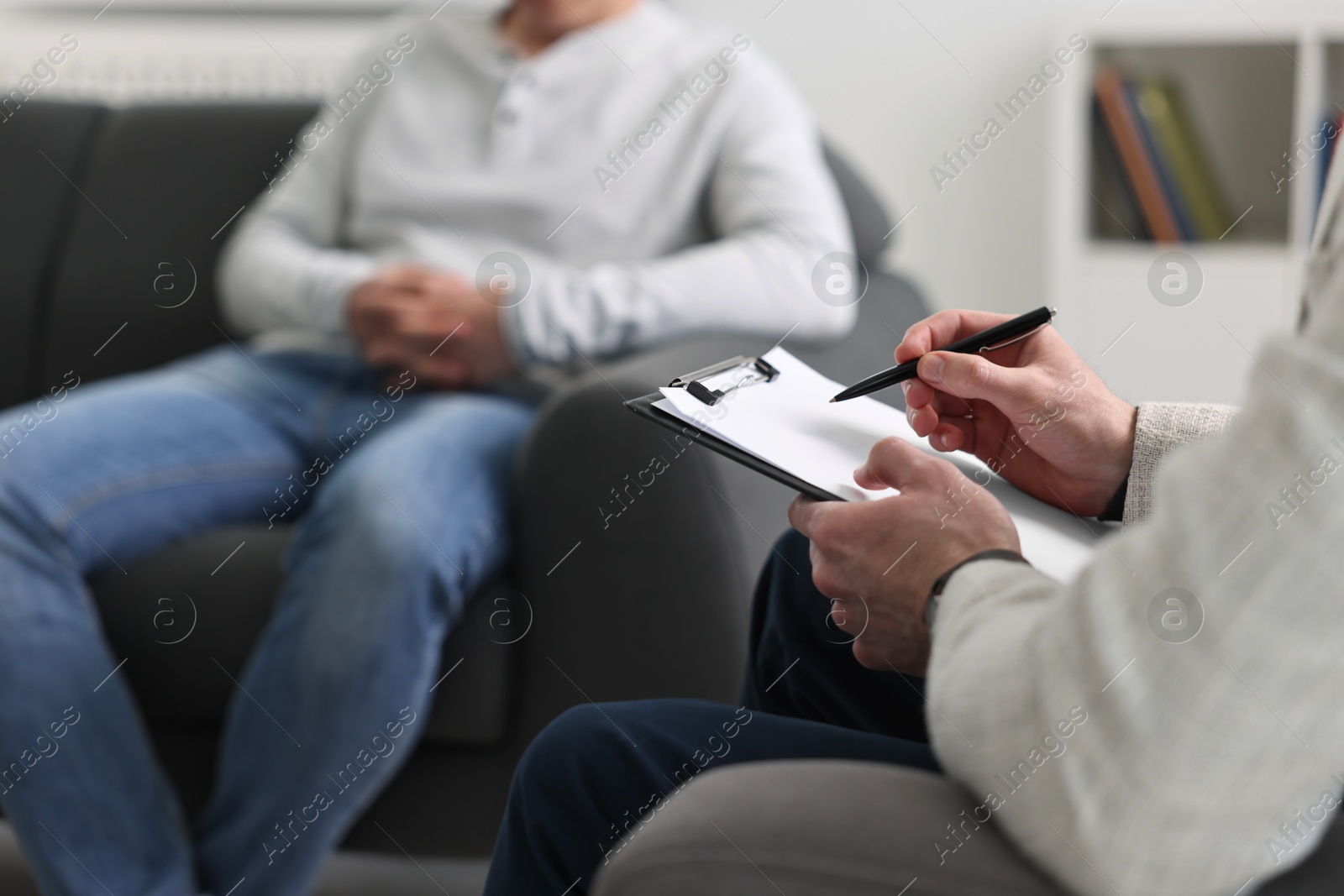 Photo of Professional psychotherapist working with patient in office, closeup