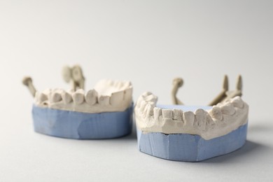 Photo of Dental model with gums on gray background, closeup. Cast of teeth