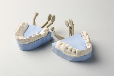 Photo of Dental model with gums on gray background. Cast of teeth