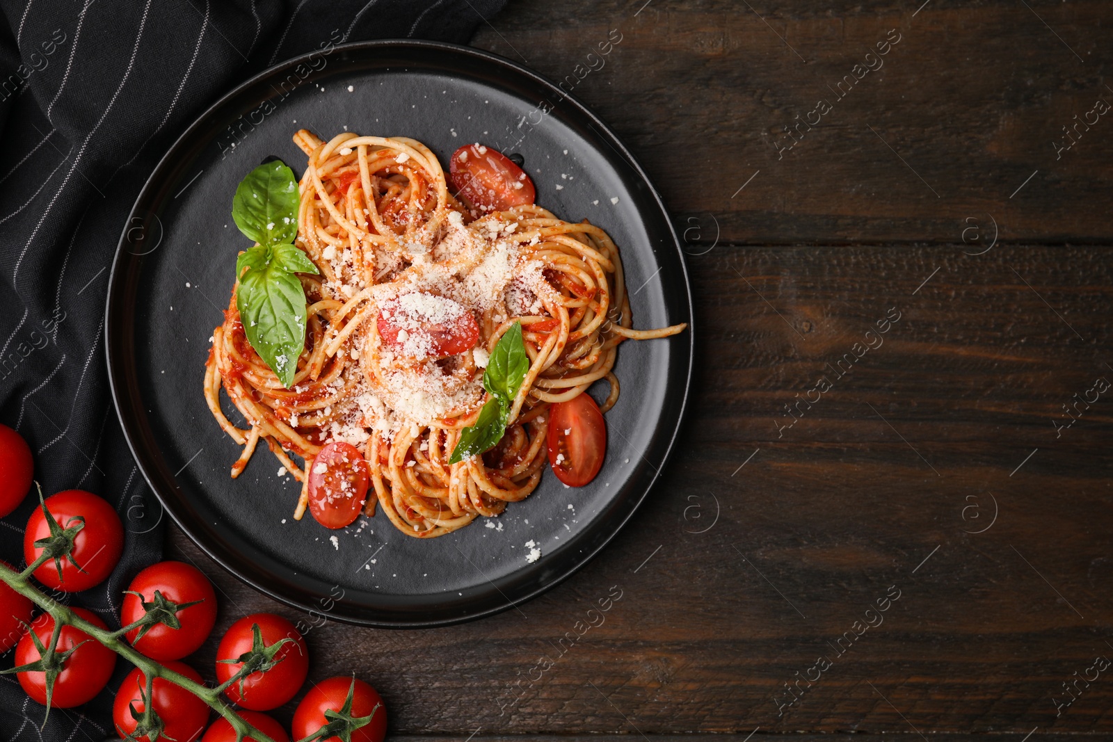 Photo of Tasty pasta with tomato sauce, cheese and basil on wooden table, flat lay. Space for text