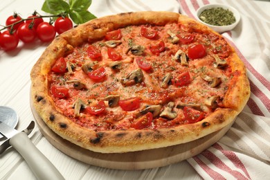 Photo of Tasty pizza with mushrooms, herbs and tomato on white wooden table, closeup