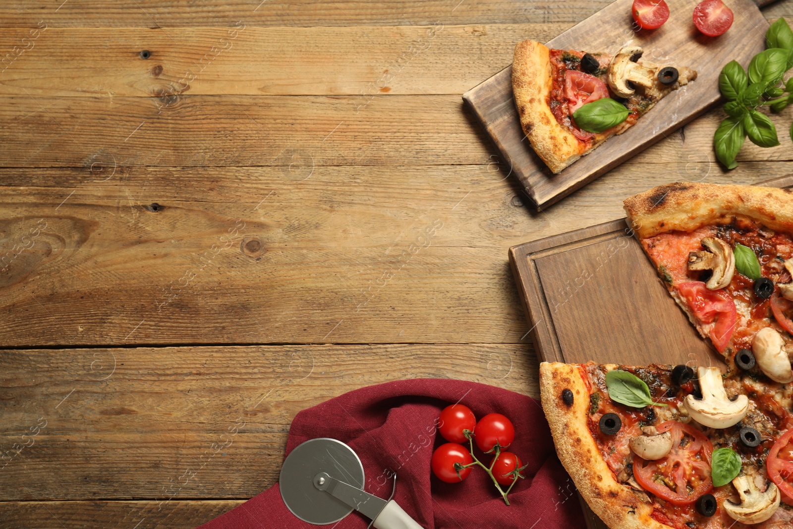 Photo of Tasty pizza with basil, mushrooms, olives and tomato on wooden table, flat lay. Space for text