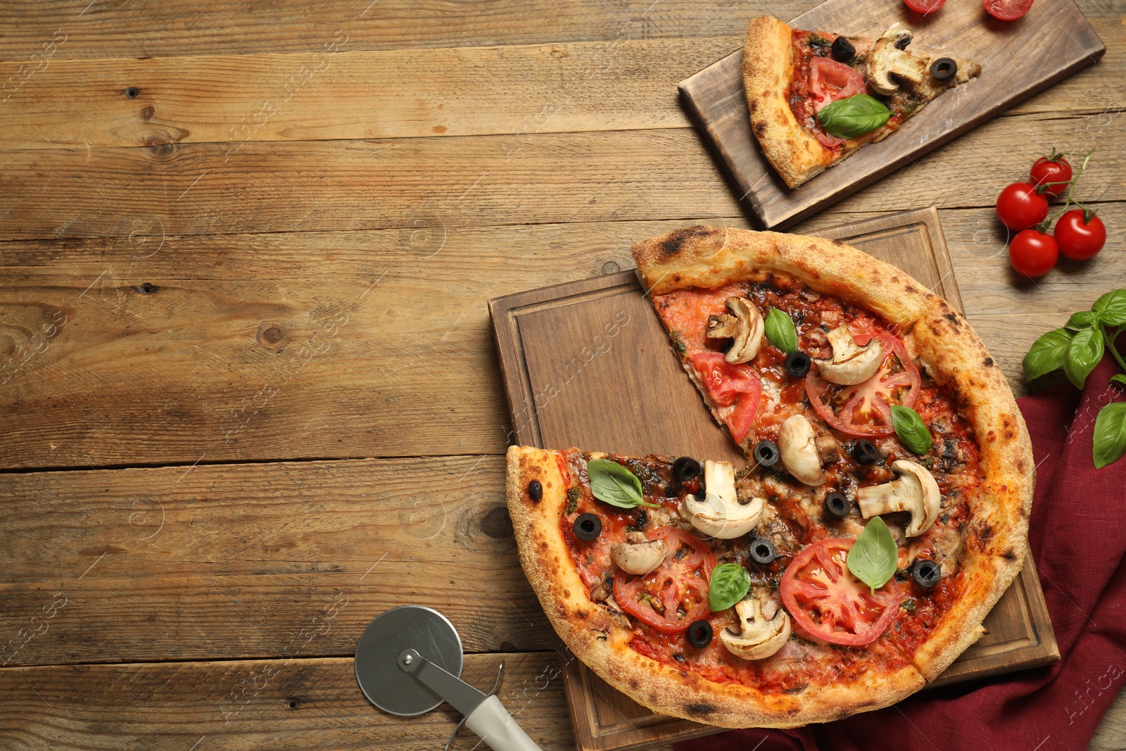 Photo of Tasty pizza with basil, mushrooms, olives and tomato on wooden table, flat lay. Space for text