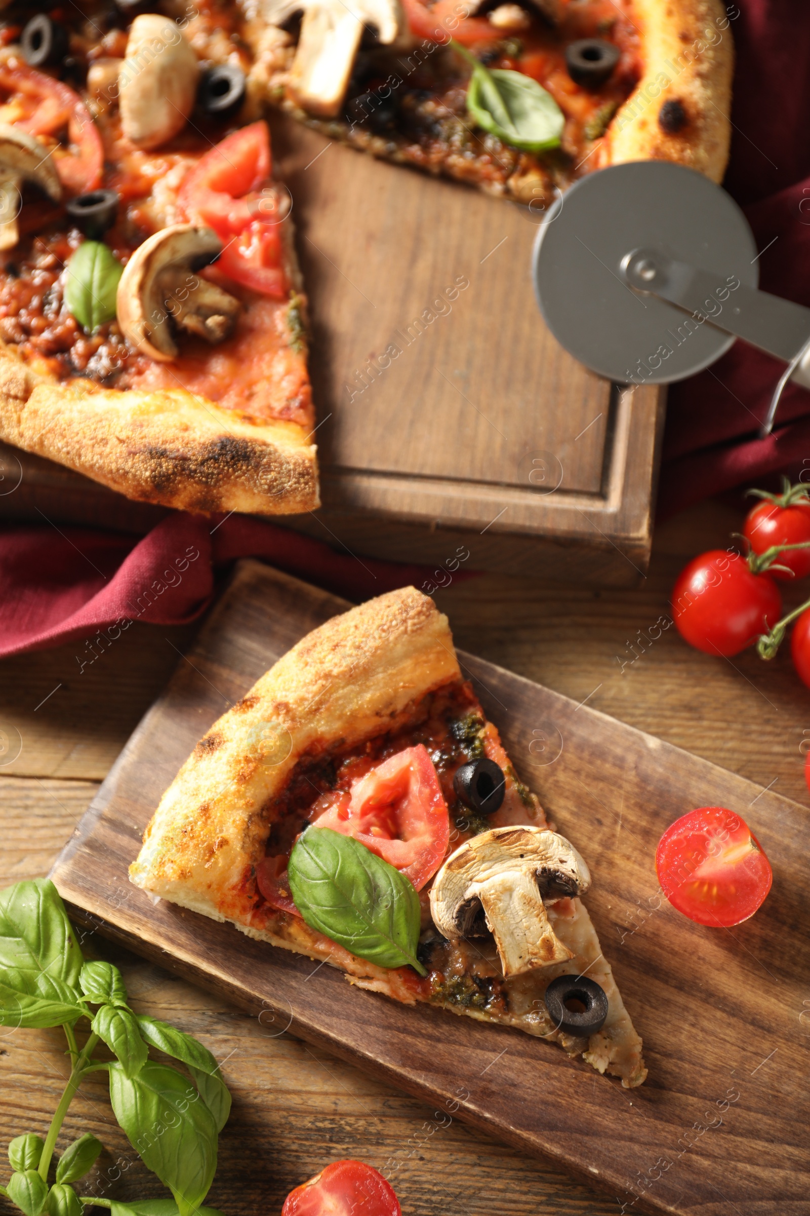 Photo of Tasty pizza with basil, mushroom, olives and tomato on wooden table, flat lay