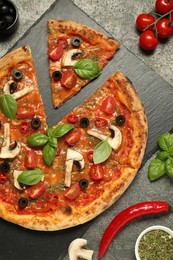 Tasty pizza with basil, olives and ingredients on grey textured table, flat lay