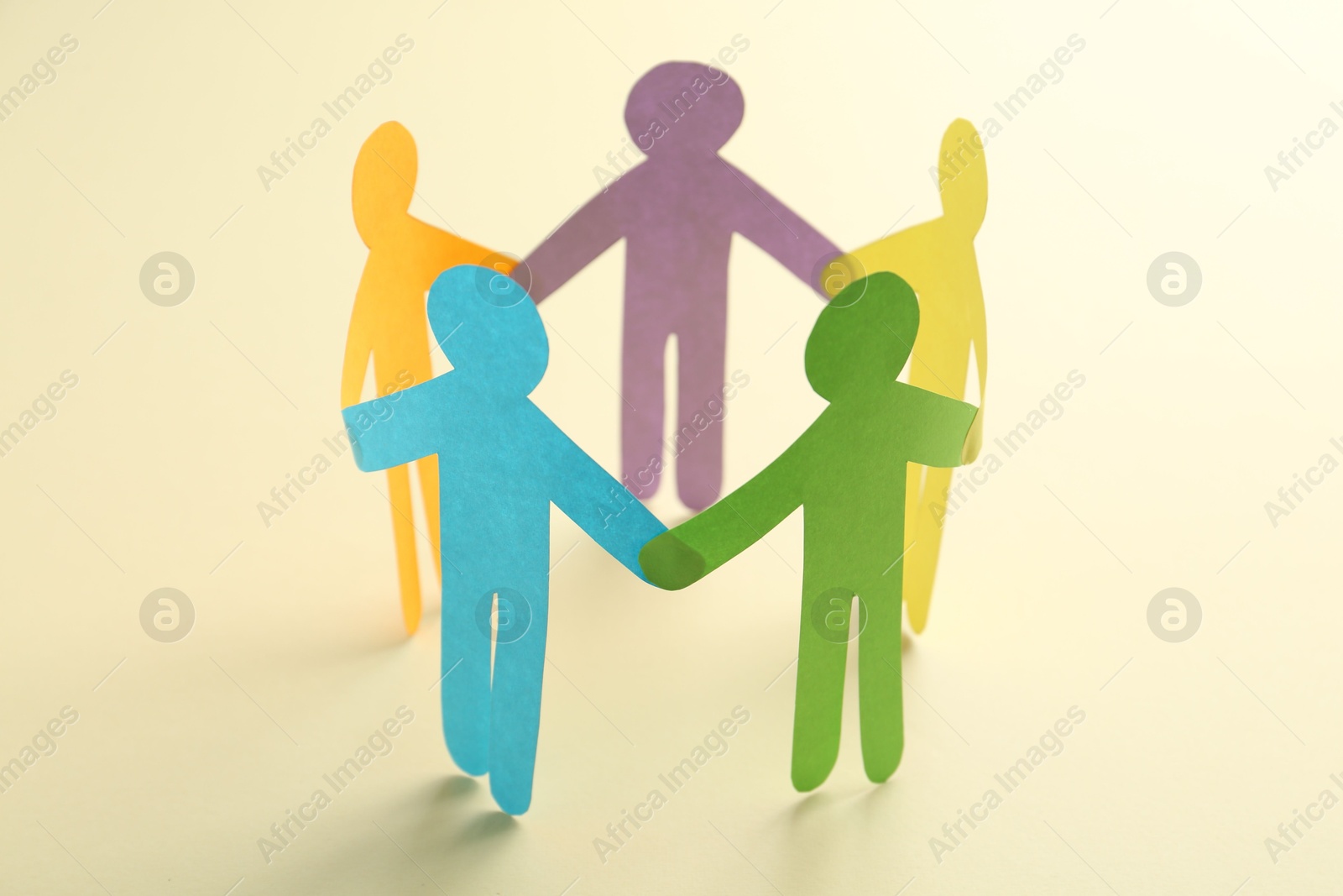 Photo of Equality concept. Paper human figures on beige background, closeup