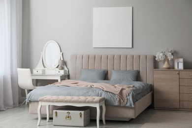 Photo of Stylish bedroom with double bed and dressing table. Modern interior