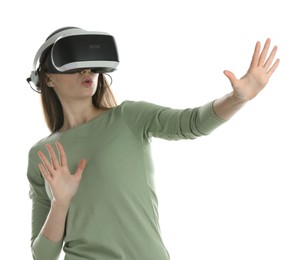 Surprised woman using virtual reality headset on white background