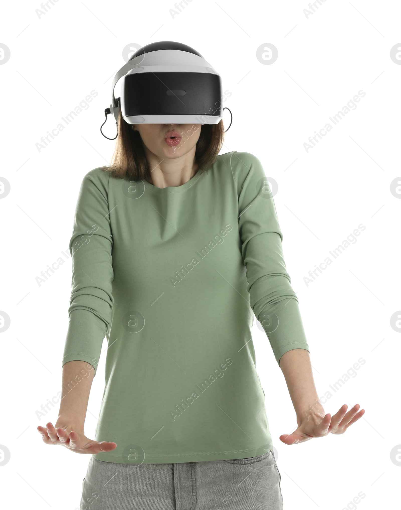 Photo of Surprised woman using virtual reality headset on white background